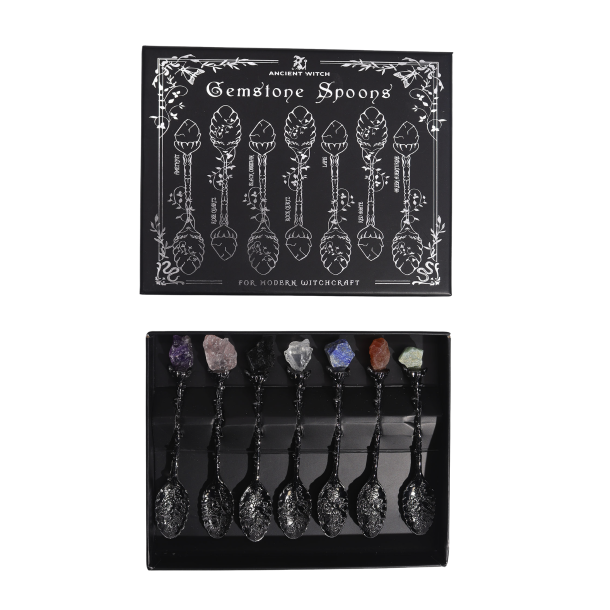 Gemstone Witch Spoons spirituelt s�t med 7 krystalskeer i m�rkt s�lv pr�senteret i en illustreret sort gave�ske.