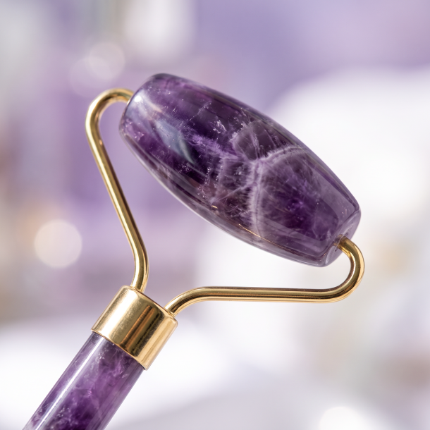 Gemstone Face Roller i �gte Ametyst med smukke lilla �retegninger, gyldne messingdetaljer og to massagehoveder.