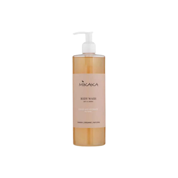 Opretst�ende transparent flaske med Mikaka Body Wash Oat & Linden. S�ben har en gylden farve, og den elegante etiket er ferskenfarvet med et smukt, minimalistisk botanisk logo.