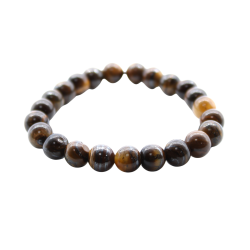 N�rbillede af Tiger�je Power Armb�ndet set fra en skr� vinkel. Man ser de polerede, gyldenbrune krystalperler og m�rket, der er fastgjort med en jutesnor. Armb�ndet er one-size og elastisk.