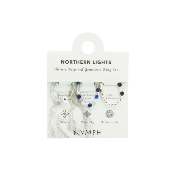 Nymph 'Northern Lights' �delstensringe s�t pr�senteret p� originalt display-kort. Billedet viser tre elastiske krystalringe med lapis lazuli og labradorit ud for deres unikke navne og symboler: Aurora, Polar Sky og Arctic Circle.