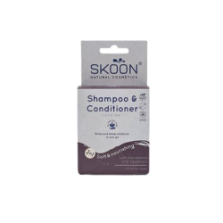 Opretst�ende Skoon Shampoo & Conditioner 2-i-1 solid bar �ske. �sken er gr� og dyb lilla, og teksten fremh�ver indholdet af macadamiaolie og figenekstrakt til alle h�rtyper.