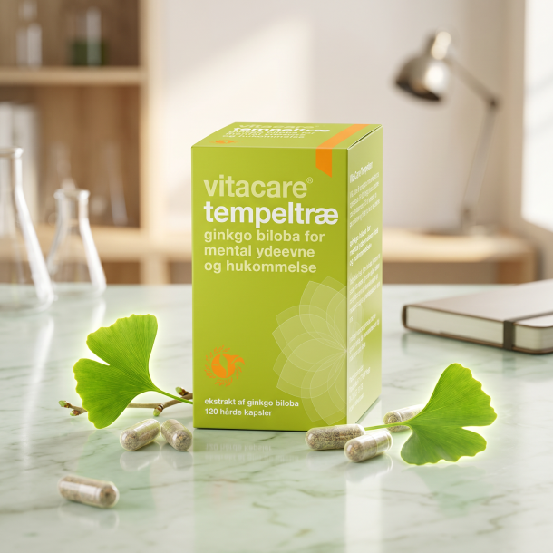 Vitacare Tempeltr� �ske pr�senteret p� lyst gr�nt marmor, ledsaget af et frisk Ginkgo Biloba-blad og plantebaserede kapsler i et eksklusivt apoteker-milj�.