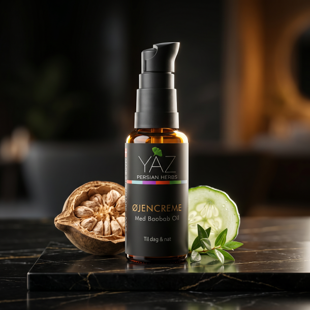 YAZ Persian Herbs �jencreme pr�senteret p� sort marmor omgivet af en eksotisk baobabfrugt og friske agurkeskiver.